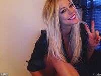 Smiling Blonde Chick Xo Gisele Is Playing With Her Enormous Boobs Before The Camera