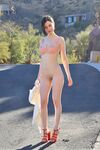 Amateur girl Giulia wanders a public road while naked in red heels